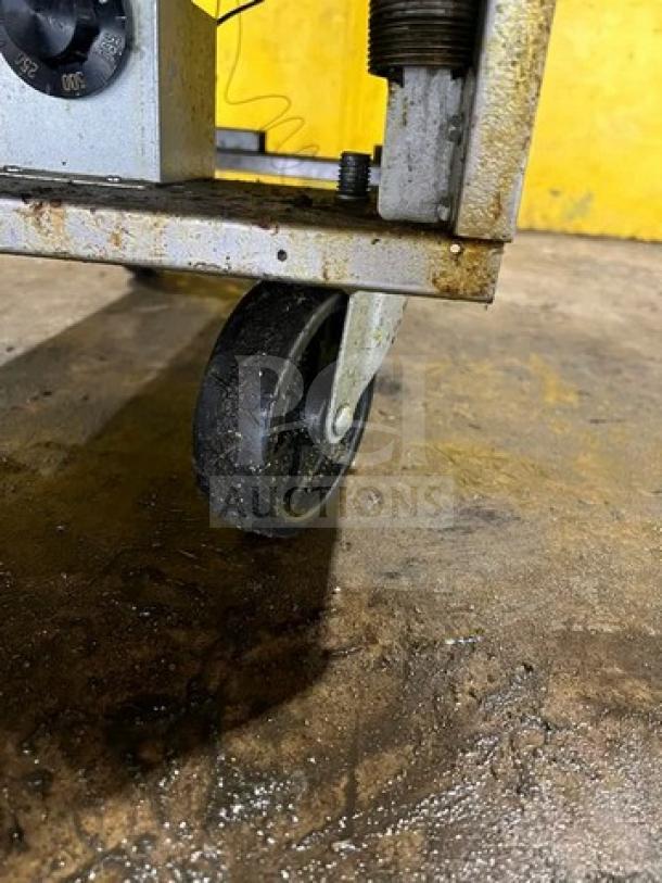 Asber AEF4050SENG deep fat fryer on caster, showing wheel detail. Rust visible on metal frame. Commercial use with natural gas.