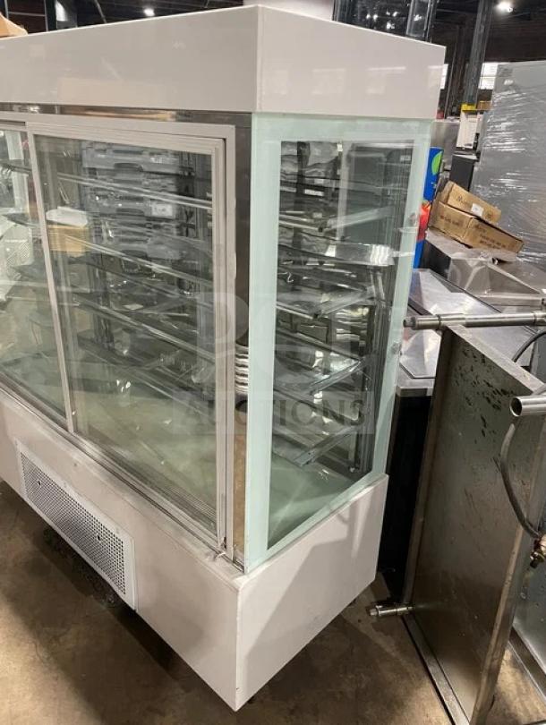 Commercial multi-tier refrigerated bakery display case, model ZSG-LLQ18, white with double glass sliding doors, 220V.