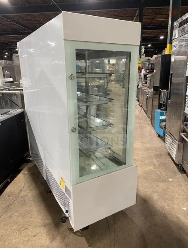 Commercial white multi-tier refrigerated bakery display with double glass sliding doors, Model ZSGLLQ18, on wheels, 220V.