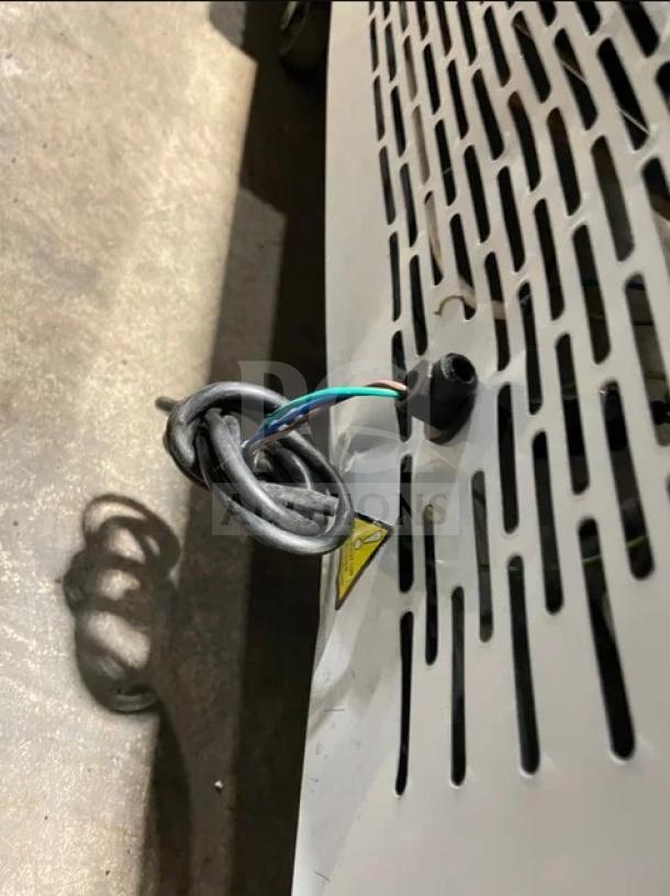 White commercial refrigerated bakery display showcase detail, Model ZSGLLQ18, features vented metal panel with wiring.