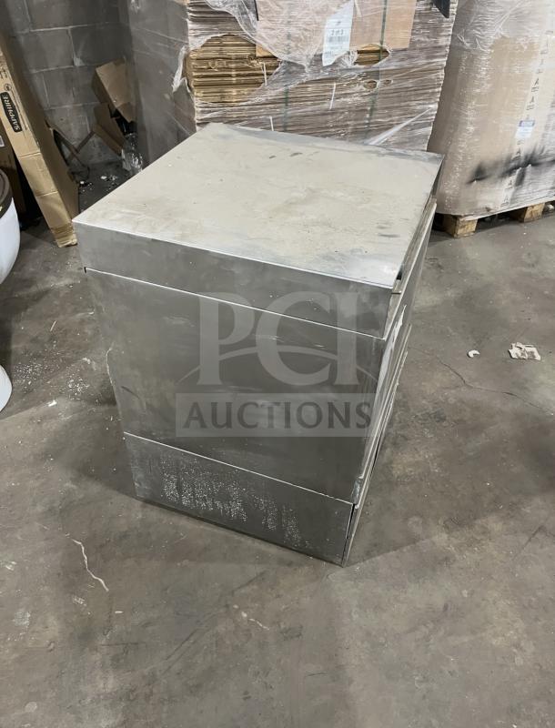 Champion stainless steel undercounter dishwasher, commercial grade, visible wear, sturdy build, industrial setting.