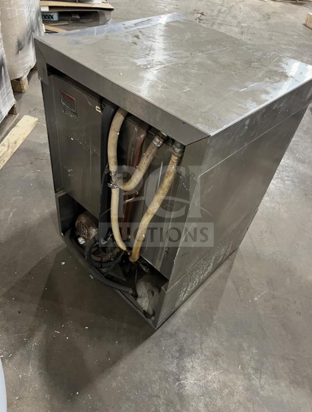 Champion commercial stainless steel undercounter dishwasher, visible wear, model tag present, plumbing connections shown.