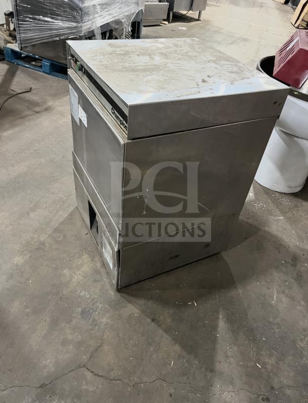 Champion commercial undercounter dishwasher in stainless steel, showing signs of use. Includes visible control panel and label.
