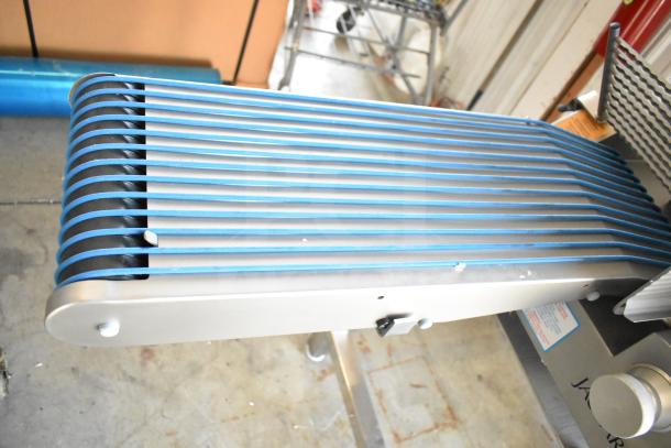 Jaccard Conveyor Commercial Floor Style Meat Slicer Stacker, 115 Volts, 1 Phase. Features blue conveyor bands.