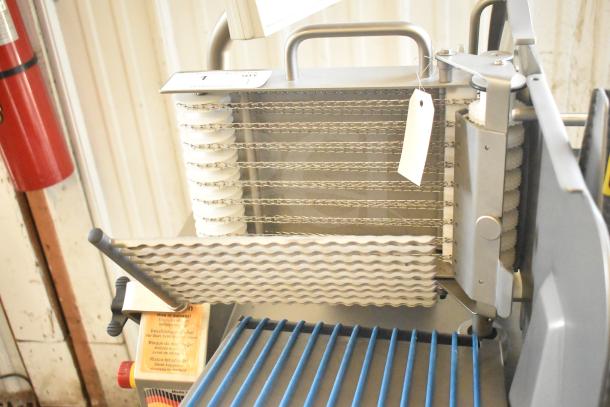 Jaccard Conveyor Commercial Floor Style Meat Slicer Stacker, 115 volts, 1 phase, with visible metal blades and operation handle.