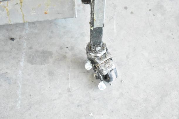 2025 Henny Penny 600 natural gas pressure fryer on casters, 80,000 BTU, showing caster detail, commercial use.