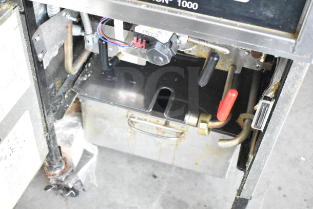 Henny Penny 600 pressure fryer, natural gas, 80,000 BTU, on commercial casters. Interior view, showing components and condition.