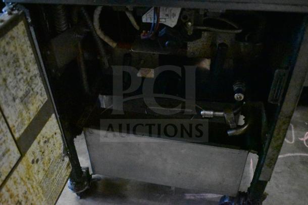 2023 Henny Penny 600 pressure fryer, natural gas, 80,000 BTU, commercial casters, visible internal components, used condition.