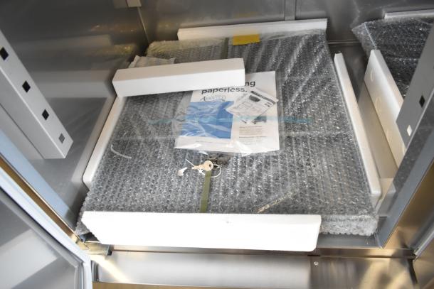 Brand new Avantco 178SS3RHC 3-door cooler interior, with manuals, keys, and packing materials, 115V, 1 phase.