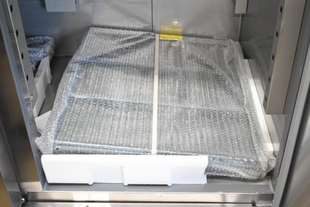 Brand new Avantco 178SS3FHC 3-door commercial freezer, 115V 1-phase, shown in packaging, scratch and dent condition.