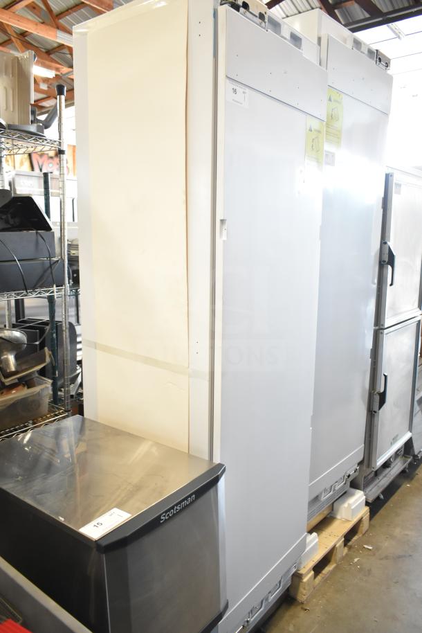 Brand new single door reach-in cooler, 115 volts, 1 phase, with visible scratch and dent marks.