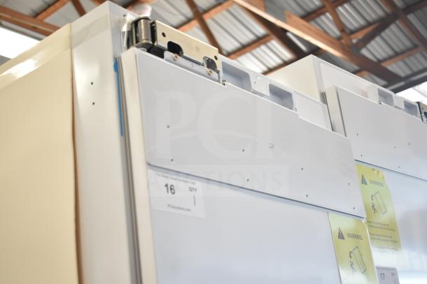 Brand new single door reach-in cooler, 115 volts, 1 phase, with minor cosmetic scratches. Tags indicate size and warnings.