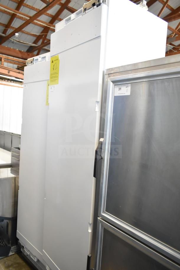 Brand new single door reach-in cooler, 115 volts, 1 phase, slight scratches, and dents, white exterior, auction item tag visible.
