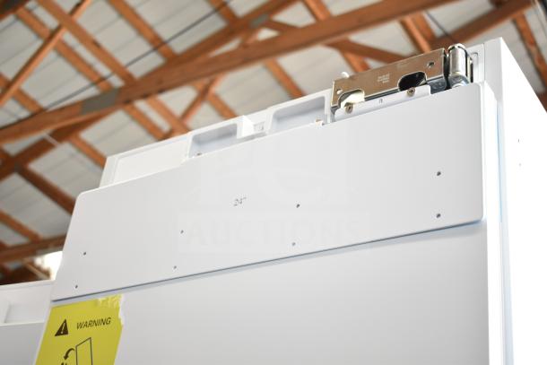 Single Door Reach In Cooler, brand new with minor scratches and dents. 115 volts, 1 phase. Warning label visible.