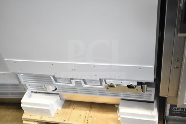 Brand new single door reach-in cooler, scratch and dent condition, 115 volts, 1 phase, features visible dents.