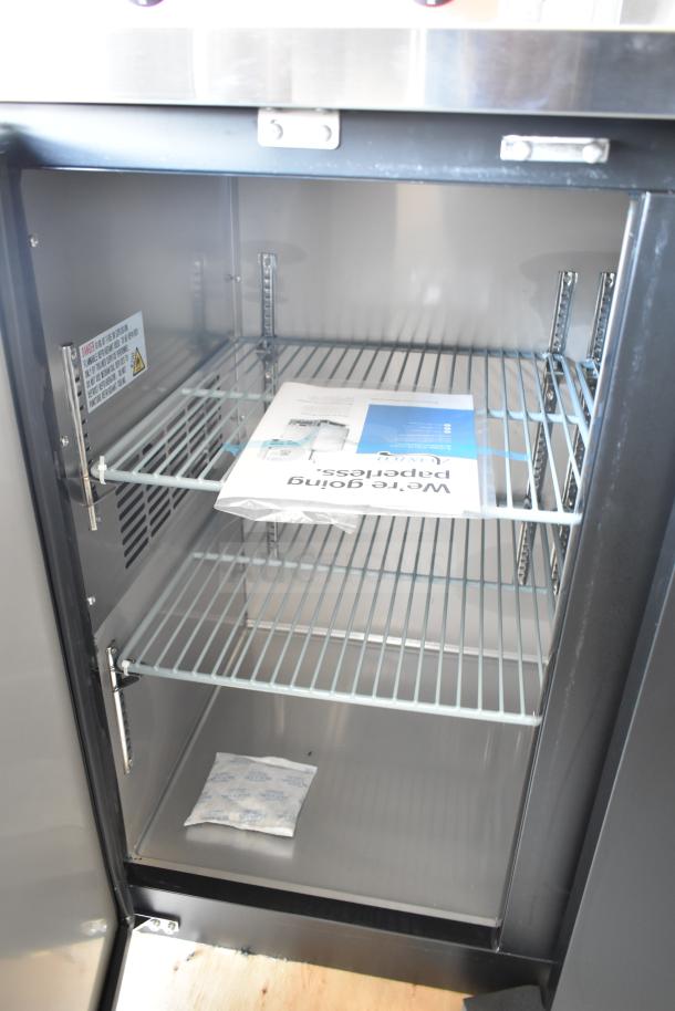 Brand new Avantco 178UBB48HC 48" black back bar refrigerator, scratch and dent, with LED lighting, inside view.