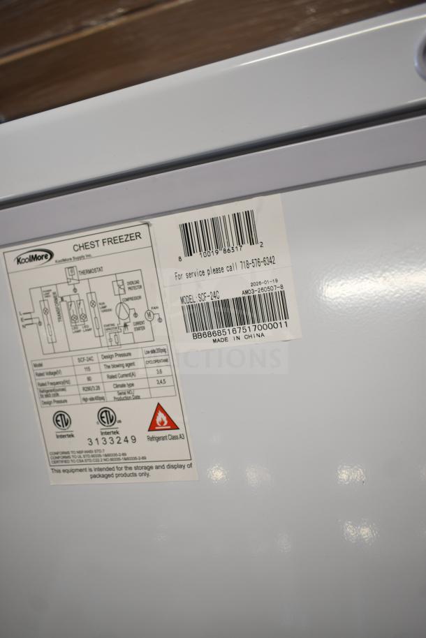 Brand new KoolMore SCF-24C chest freezer. 24 cu ft, 115V, scratch and dent model. Labels show model and specifications.