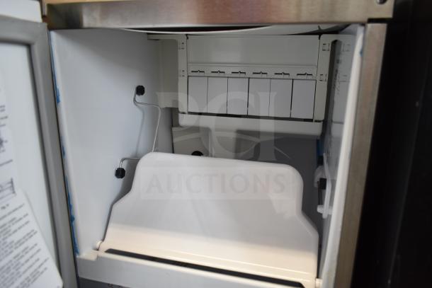 2024 Hoshizaki AM-50BAJ-DS ice machine interior, new condition; features a 27 lb. bin and top hat cube maker.