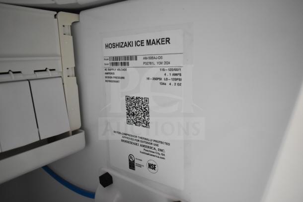 Alt text: Hoshizaki AM-50BAJ-DS ice machine label showing model, voltage, amperes, design pressure, and refrigerant details.