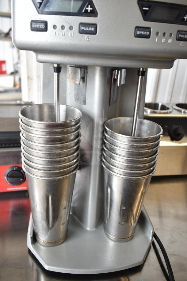 Waring WDM240TX Double Spindle Drink Mixer, 3-speed with timer. Features metal cups, 120V, 1 phase. Slight wear visible.