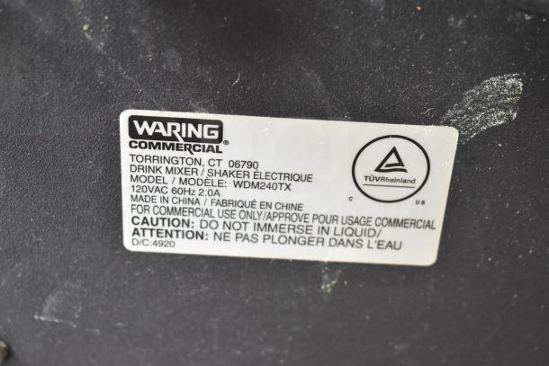 Waring WDM240TX double spindle drink mixer label, showing model, voltage, and caution details for commercial use.