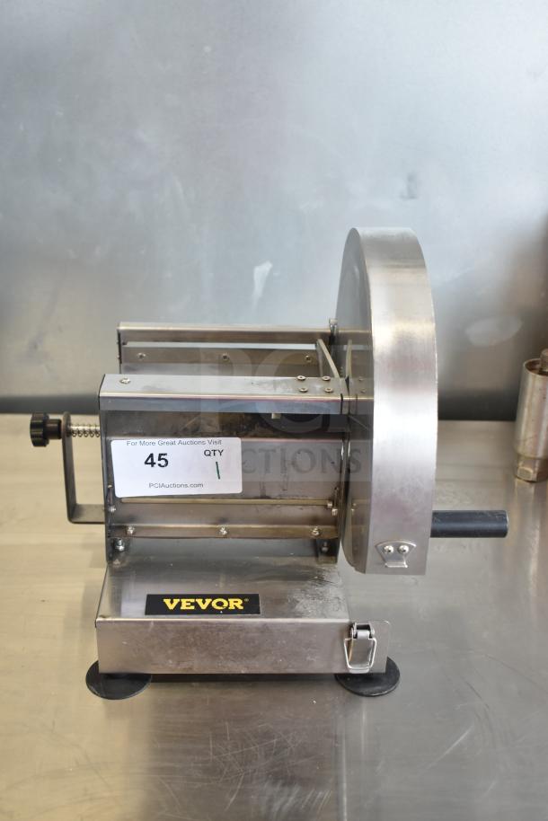 Vevor Countertop Vegetable Slicer in stainless steel, featuring a manual crank. Good condition with visible PCI Auctions label.
