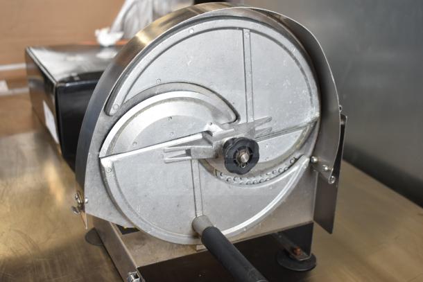 Vevor countertop vegetable slicer with metal disc, sturdy construction. Appears in good condition on a stainless surface.