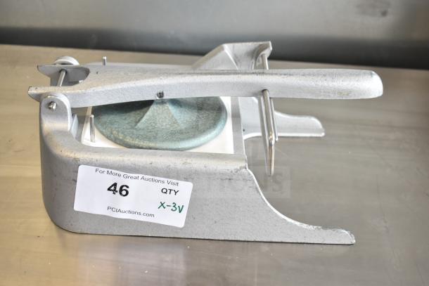 Metal patty former in good condition with a sticker labeled "46" and "X-3V". Features sturdy build and lever mechanism.