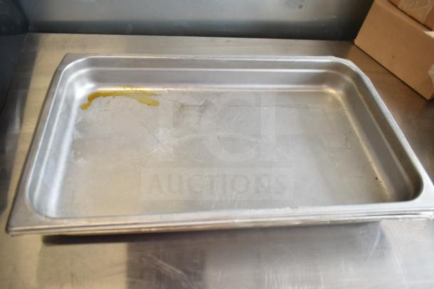 Stainless steel pan with minor wear, holding residue. Part of auction lot with patty former and drop-in bins.