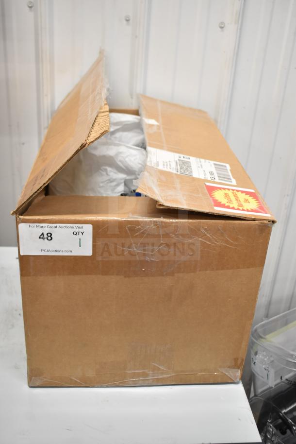 Corrigan Water Filtration System in partially opened cardboard box, visible labels with auction details, new condition.