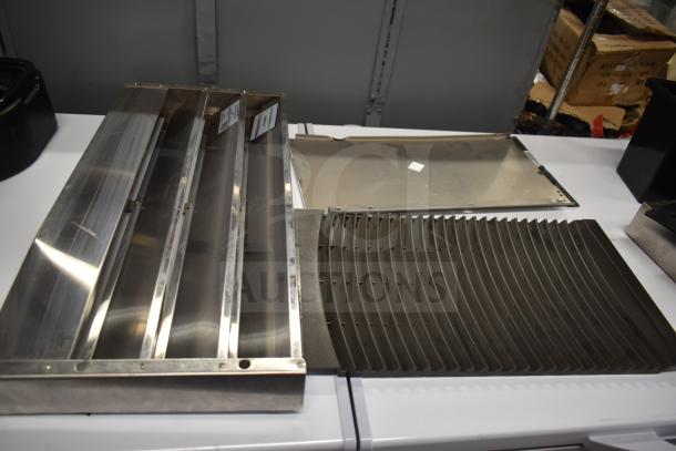 Stainless steel cooler kick plate and ice machine head screen piece displayed on a white surface. 8 items in total.