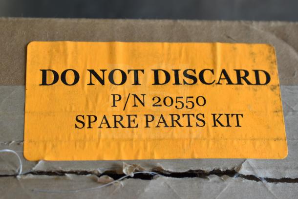Cardboard box with yellow label reading "DO NOT DISCARD, P/N 20550, SPARE PARTS KIT."