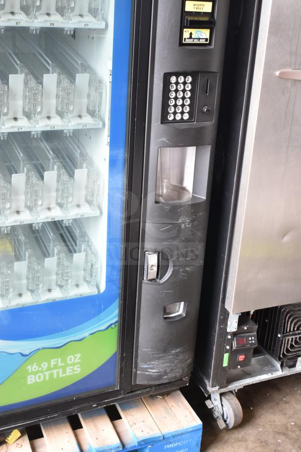 Crane 5800-4 metal commercial vending machine, bill acceptor, 115 volts, 1 phase, visible slots for 16.9 fl oz bottles.