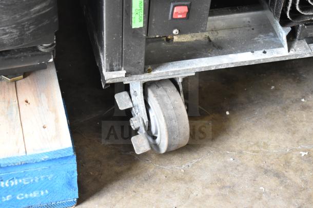 Beverage Air SF1HC-1S commercial freezer caster showing wear. 115V, 1 Phase. Visible inspection tag and power switch.
