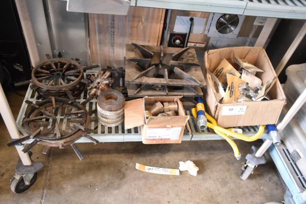 32 assorted items including range grates, gas hose, and fittings. Various conditions. Bulk box purchase.