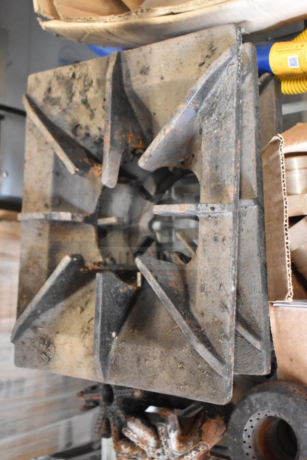 Industrial range grate with visible rust, part of a lot of 32 items including a gas hose. Sold as is, multiple units per bid.