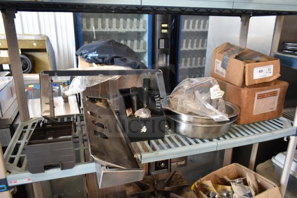 Shelf with 16 various items including portafilters, Turbo Air CONLOOP2848 condensate loop, and poly pieces for ice cream machine.