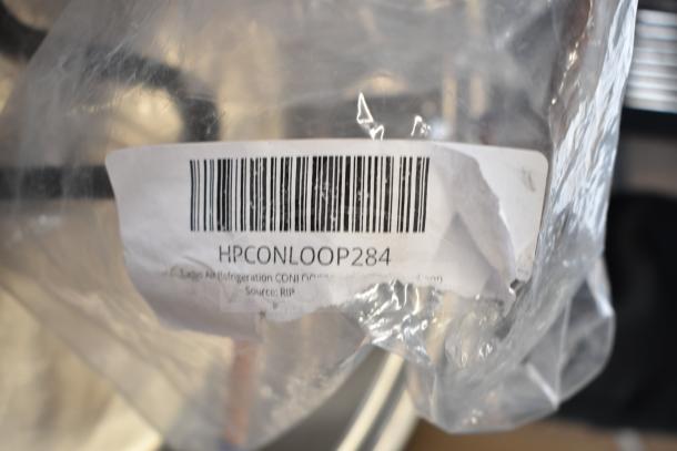 Close-up of a label on clear packaging reading "HPCONLOOP284" for Turbo Air Refrigeration component.