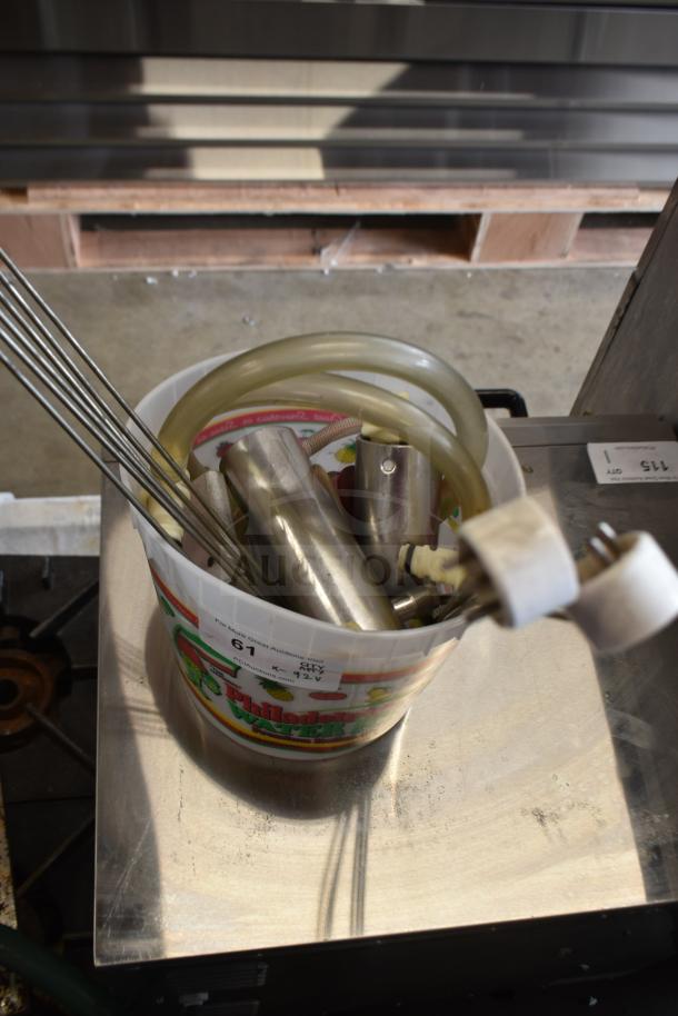 Bucket containing 92 various ice cream machine parts, including handles, hoses, and metal components. Suitable for repair or replacement.