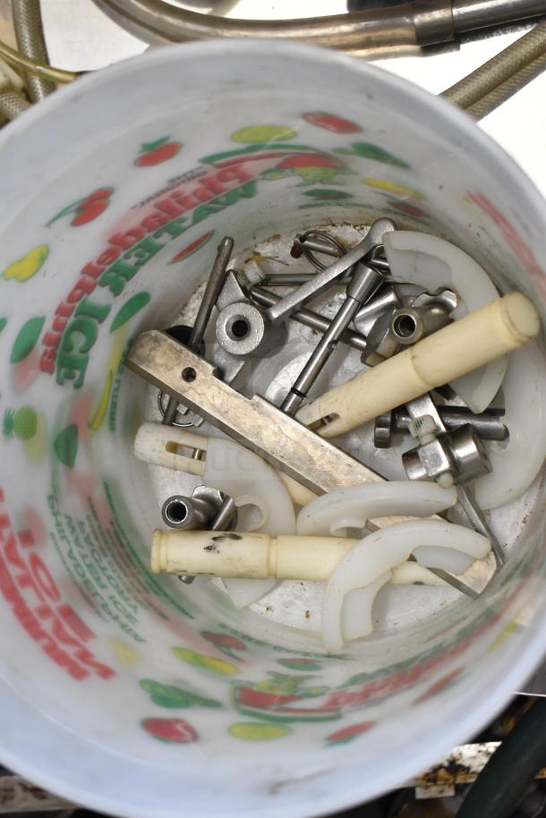 92 various ice cream machine parts in a container, including handles, metal components, and plastic pieces. Good condition.