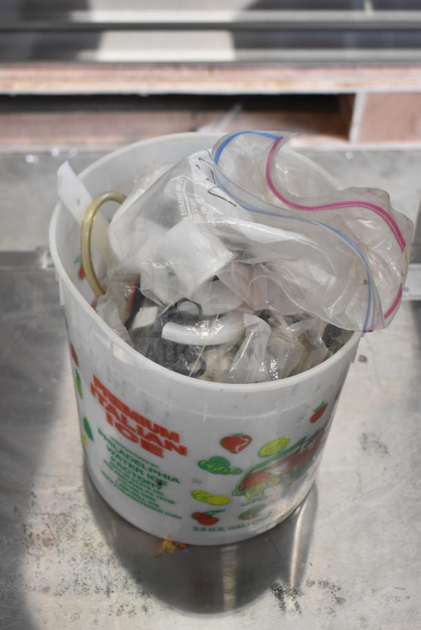 Bucket of 92 various ice cream machine parts, including handles, assorted in plastic bags. Used condition.