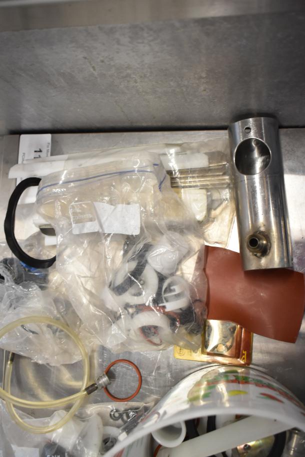 92 assorted ice cream machine parts, including handles and hoses, in various conditions, some in Ziploc bags.