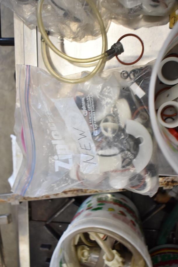 Bag of various ice cream machine parts including handles, gaskets, and tubes. Bag labeled "New." Lot of 92 items.