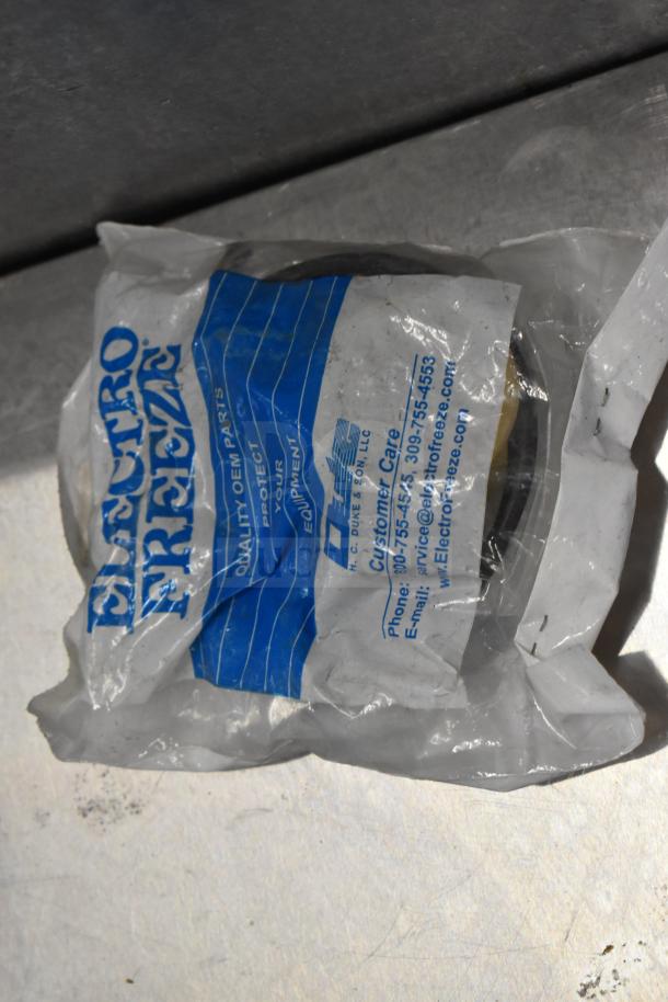 Bag of Elector Freeze ice cream machine parts, OEM quality, including handles. Package details customer care info.