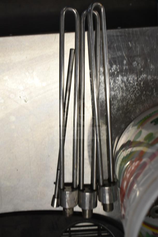 92 various ice cream machine parts including metal handles, shown on a metal surface.