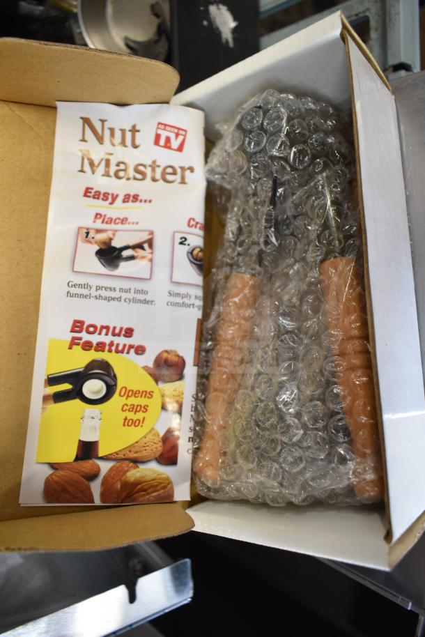 Boxed Nut Master K2811, bubble-wrapped, "As Seen on TV" label, bonus feature to open bottle caps, pristine condition.