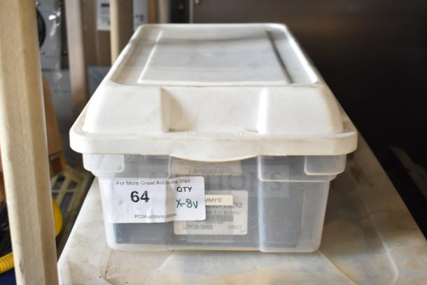 Plastic storage box labeled "64," containing various items including AX35 Belt and Taylor Probe X31602. Auction lot.