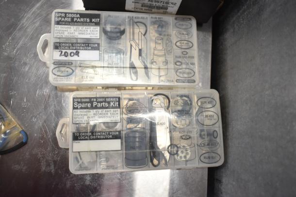 Two labeled spare parts kits, SPR 5800A and SPR 5600: FB 2001, with various components inside a plastic case.