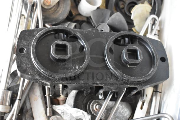 Assorted Taylor ice cream machine parts, including metal components and fittings, in used condition. 54 items available.