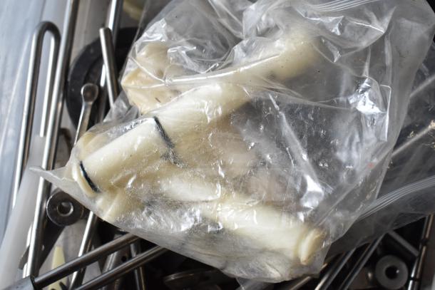 Assorted Taylor ice cream machine parts in plastic bags, mixed metal rods visible, quantity of 54.